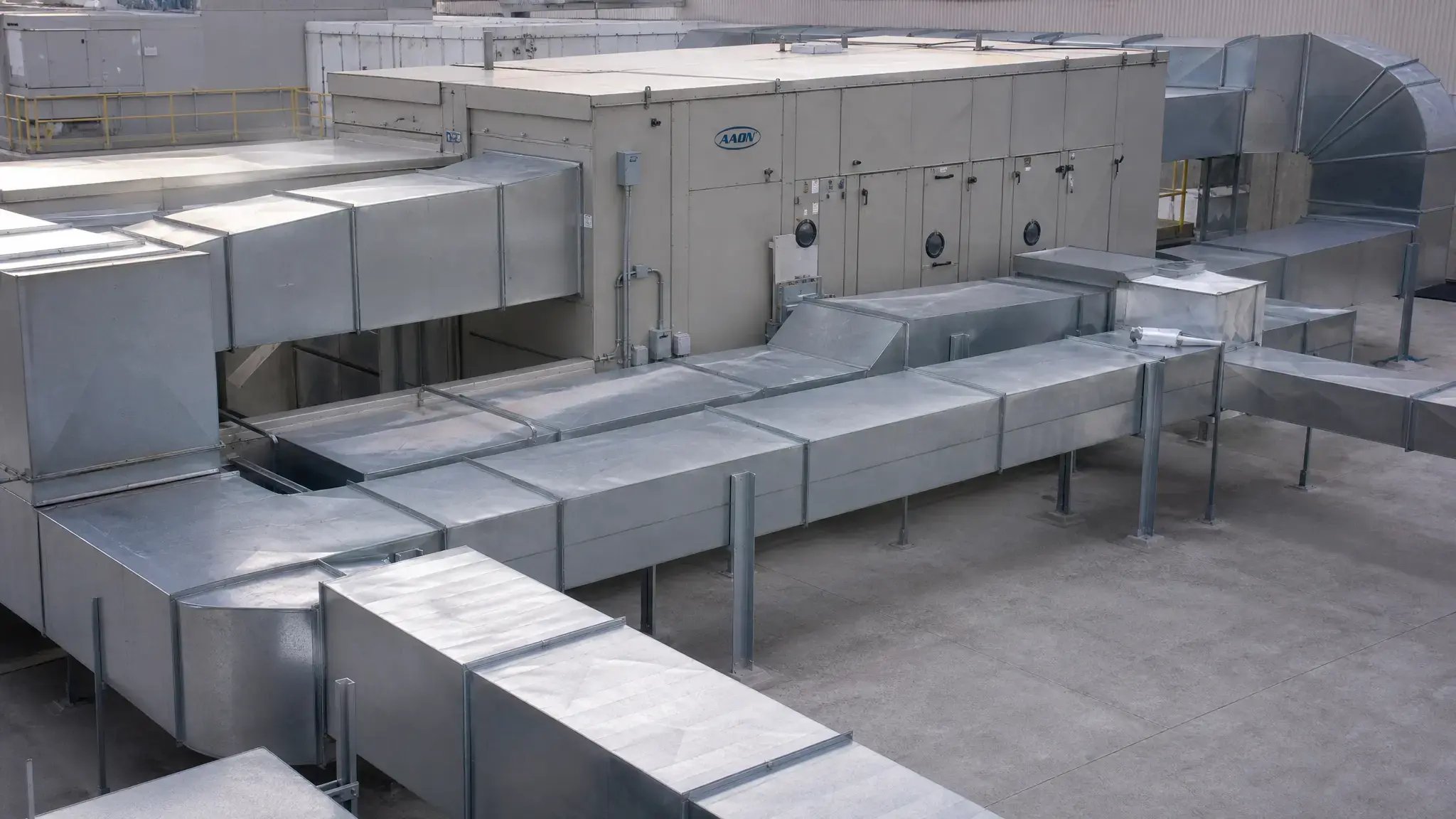 Commercial HVAC ductwork system in an industrial facility requiring inspection and cleaning
