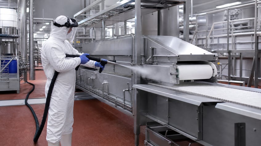 technician using dry ice blasting to clean food processing equipment
