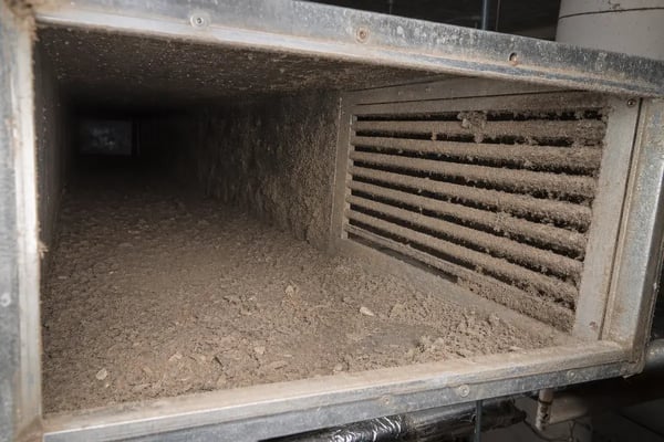 contaminated commercial air duct interior with dust and debris buildup