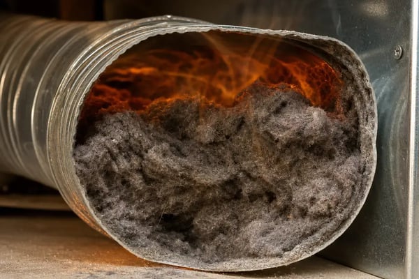 lint buildup clogging commercial dryer exhaust duct