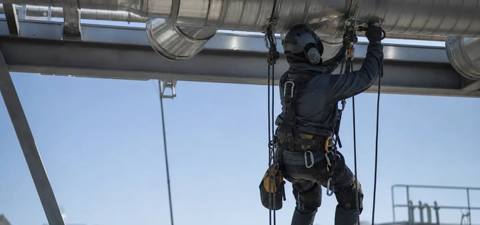 Service-Tech technician equipped with fall protection gear for rope access services