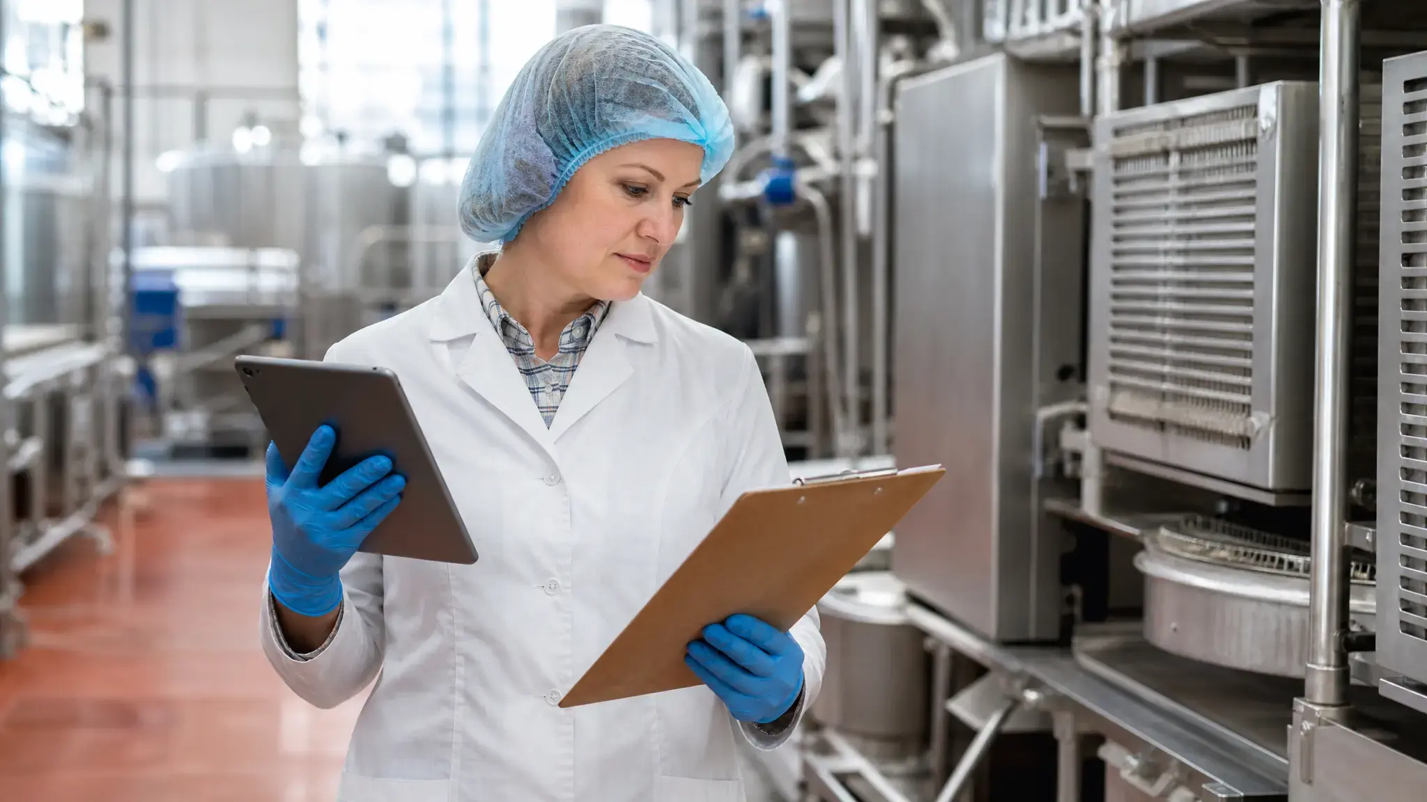 sanitation supervisor reviewing food plant cleaning schedule checklist