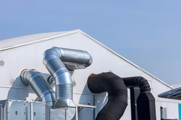 Dust collector ductwork mounted outside an industrial building