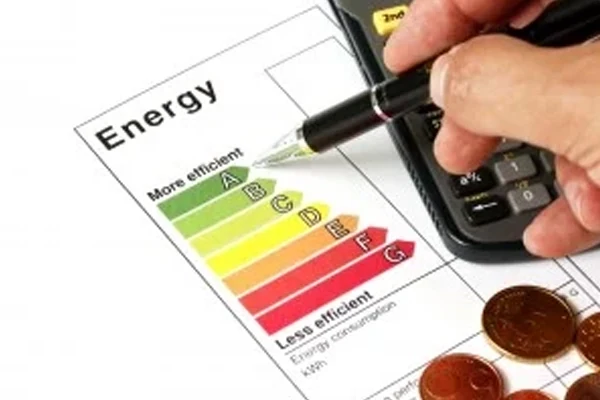 Energy efficiency rating chart with a calculator and coins, representing HVAC energy savings
