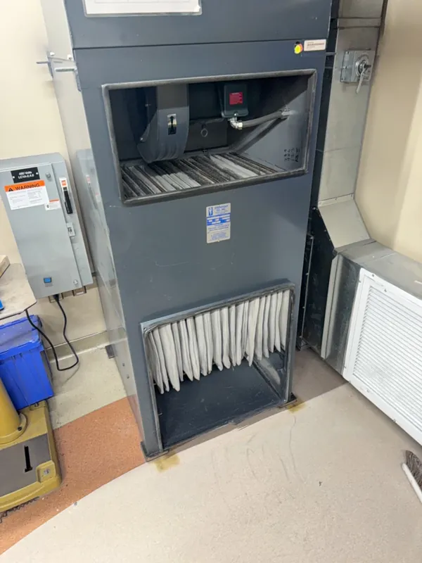 After: the same air handler with fresh filters and a clean floor after Service-Tech air duct cleaning