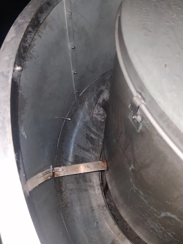 Before: round duct transition lined with dust before Service-Tech air duct cleaning