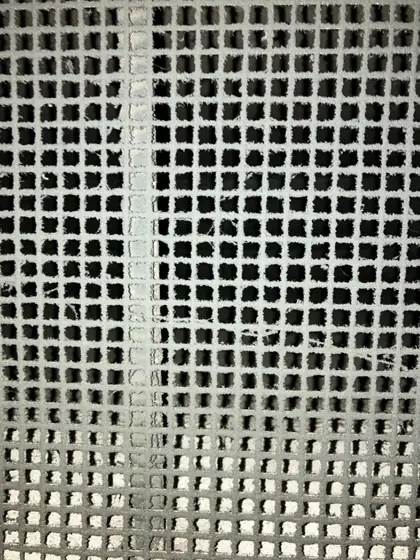 Before: intake screen clogged with dust before Service-Tech air duct cleaning