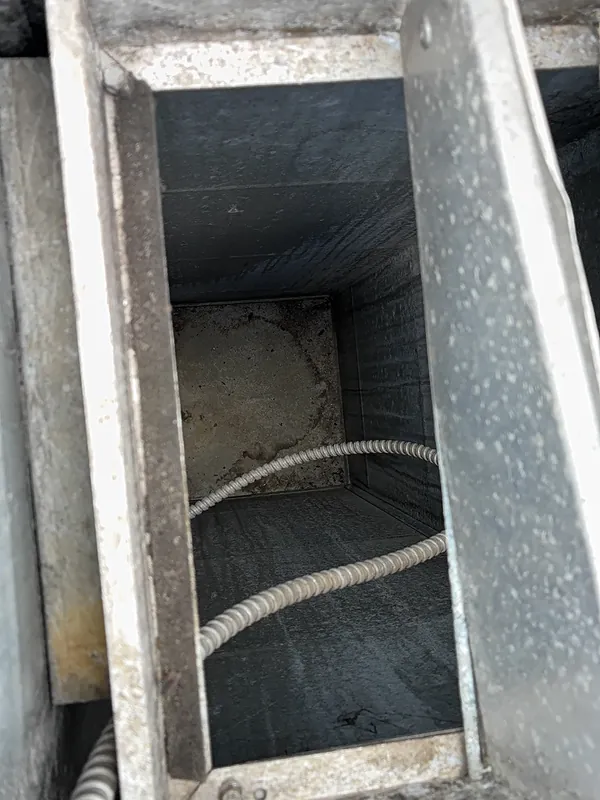 Before: rooftop return duct with dust built up inside before Service-Tech air duct cleaning