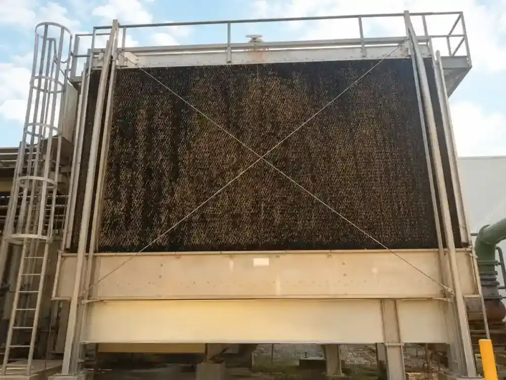 Commercial cooling tower with fouled fill media awaiting Service-Tech cleaning