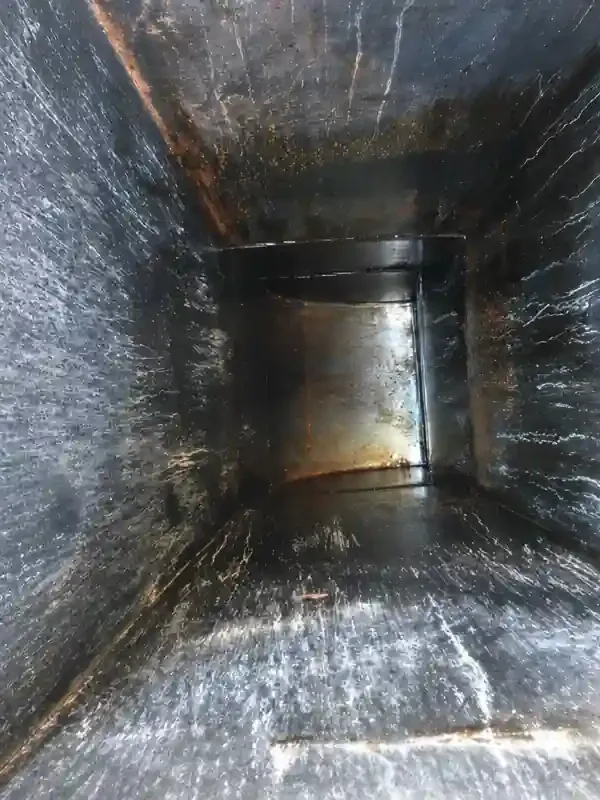 After: the same grease duct cleaned to bare metal by Service-Tech