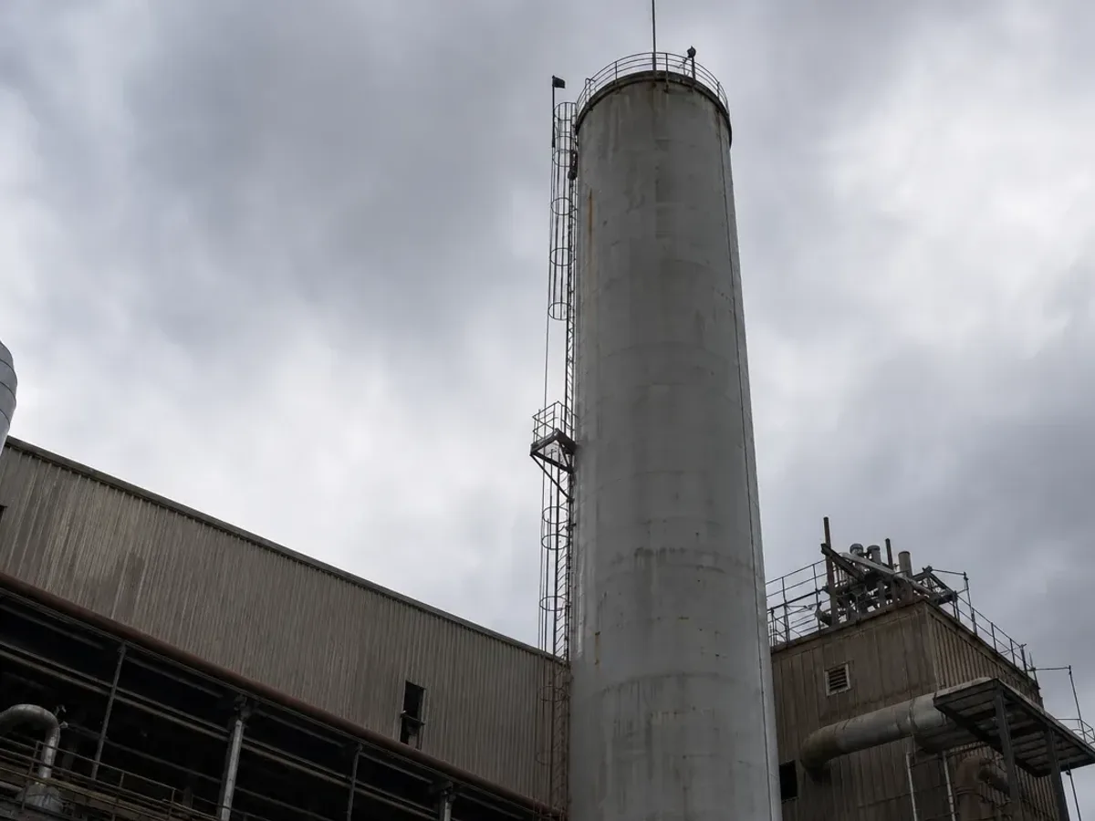 Tall industrial exhaust stack serviced by Service-Tech rope access technicians